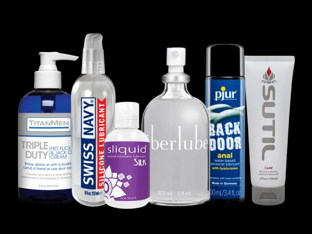 Collection of various lubricant products with visible branding on a black background